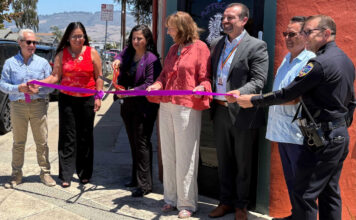 Santa Cruz County District Attorney Jeff Rosell, left, joins Aztecas Youth Soccer Academy founder Gina Castañeda, Chief Probation Officer Sandra Mendez, 1440 Multiversity co-creator Joanie Kriens, Santa Cruz County Superintendent of Schools Faris Sabbah, Ramon Gomez from Santa Cruz County Supervisor Felipe Hernandez’s office and Watsonville Police Chief Brian Shab in a ribbon-cutting ceremony at Aztecas new clubhouse.