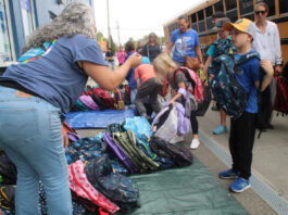 Stuff the Bus volunteers pack 2,500 backpacks for students