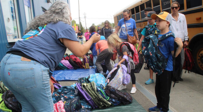 Stuff the Bus volunteers pack 2,500 backpacks for students
