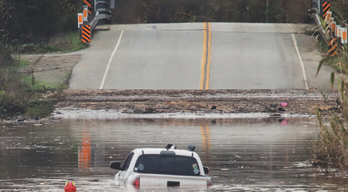 County prepares for potentially strong El Niño A State Parks Rescue swimmer paddles to shore from a pickup that stalled in flood water on Paulsen Road in 2023. New funding could help prevent this annual event.